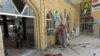 Men clean up after a bomb detonated at a Shi'ite mosque in the northern city of Kirkuk on April 19.