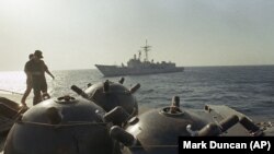 Mines aboard the ship Iran Ajr are inspected by a boarding party from the USS LaSalle in the Persian Gulf, Sept. 1987.