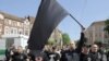 Followers of Germany's neo-Nazi NPD party wave a black flag during May Day demonstrations in Berlin's Koepenick district on May 1, 2009.