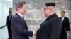 South Korean President Moon Jae-in (left) shakes hands with North Korean leader Kim Jong Un during their summit in the truce village of Panmunjom, North Korea, in this handout picture provided by Seoul's Presidential Blue House on May 26. 