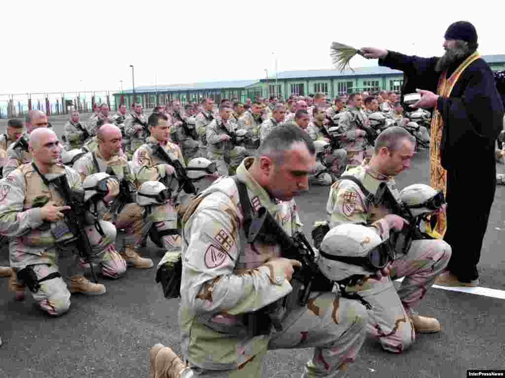 A priest says a blessing for Georgian servicemen leaving for Afghanistan to join NATO-led troops in Helmand. - Some 750 Georgian troops will join another 150 already serving in the NATO coalition in Afghanistan.Photo by InterPressNews