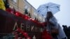 A woman lays flowers for the victims of the St. Petersburg blast by the Kremlin walls in Moscow.