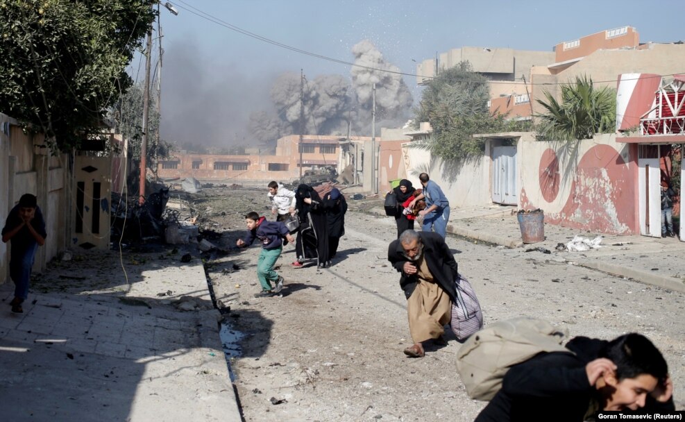 Veteran war photographer Goran Tomasevic knew what was coming moments before this air strike hit a position held by the extremist group Islamic State during the battle for Mosul. He told a Reuters colleague that civilians had come out on the street during a lull in the fighting when a low-flying jet suddenly shrieked past. "It was close and total panic ensued," he was quoted as saying about the November event. "People were screaming, ducking and running away as the plumes of smoke rose nearby. "They quickly ran for whatever shelter they could find.... These things happen fast and you have to act quickly. First you have to make sure you are safe, then stay focused so you can get the shot. You get your lens ready and stay calm."