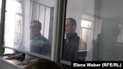 Uali Aliasqarov (left) and Mikhail Tkachyov in court in Qaraghandy on November 21. 
