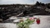 Flowers and candles are placed near wreckage at the crash site of Malaysian Airlines Flight 17 near the village of Grabovo on July 19, 2014, two days after the plane was shot down.