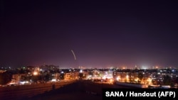A handout picture released by the official Syrian Arab News Agency (SANA) on September 15, 2018, reportedly shows Syrian air defense batteries responding to what the Syrian state media said were Israeli missiles targeting Damascus international airport.