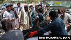 A victim, injured in an explosion at a cattle market in Helmand's Sangin district, is brought to a hospital in the provincial capital Lashkar Gah on June 29.