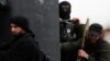 A Turkish fighter of the jihadist group Al-Nusra Front, bearing the flag of Al-Qaeda on his jacket (center), holds position with comrades in the village of Aziza, on the southern outskirts of Aleppo, in April.