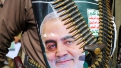 A supporter of the Houthis has a poster attached to his waist of Soleimani, during a rally to denounce the U.S. killing.