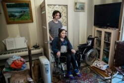 Irina Karabulatova, pushed in a wheelchair by her son Mikhail, hadn't left her Moscow apartment for a year.