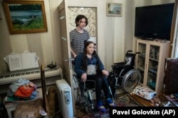 Irina Karabulatova, pushed in a wheelchair by her son Mikhail, hadn't left her Moscow apartment for a year.