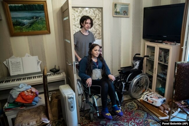 Irina Karabulatova, pushed in a wheelchair by her son Mikhail, hadn't left her Moscow apartment for a year.