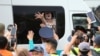 A woman reacts inside a police minibus after she was detained during a protest rally held by Kazakh opposition supporters in Almaty on July 6. (Reuters/Pavel Mikheyev)