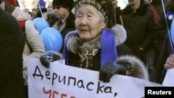 A woman shows a poster calling for the protection of Lake Baikal during an earlier rally in Irkutsk.