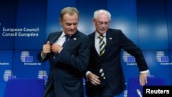 Newly elected European Council President Donald Tusk (left) holds a news conference with outgoing predecessor Herman Van Rompuy during a EU summit in Brussels on August 30.