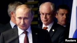 Russian President Vladimir Putin (left) is followed by European Council President Herman Van Rompuy as they arrive for a joint news conference after an EU-Russia Summit in Brussels in January.
