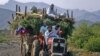 FILE: An internally displaced family flee Tora Warai, a village in Kurram tribal district.