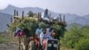 An internally displaced family flees military operations in Tora Warai, a town in Kurram Agency, in Pakistan's Federally Administered Tribal Areas (FATA) in July 2011.