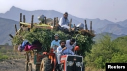 An internally displaced family flees military operations in Tora Warai, a town in Kurram Agency, in Pakistan's Federally Administered Tribal Areas (FATA) in July 2011.