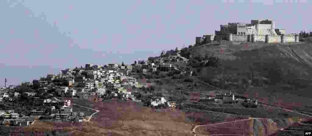 A general view of the 12th-century Crac des Chevaliers Castle and the adjacent village of Al-Hosn in the Homs region on August 19.