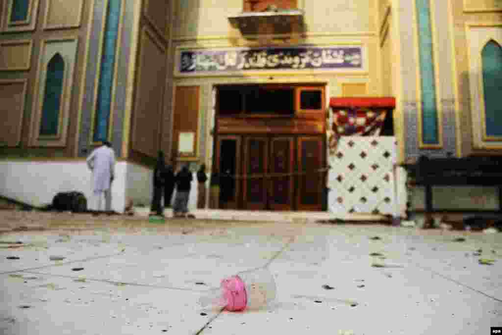 Pakistani security personnel stand guard at a Muslim Sufi shrine where a deadly bomb attack killed more than 80 people, including many children. (epa/Nadeem Khawer)