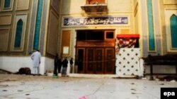 Pakistani security personnel stand guard at a Muslim Sufi shrine where a deadly bomb attack killed more than 80 people, including many children. 