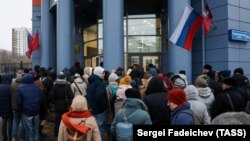 People stand outside Moscow's Tverskoi court following an anonymous bomb threat on December 4.