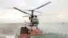 A Ka-27 lands on a frigate during naval exercises of the Baltic Fleet in 2004.