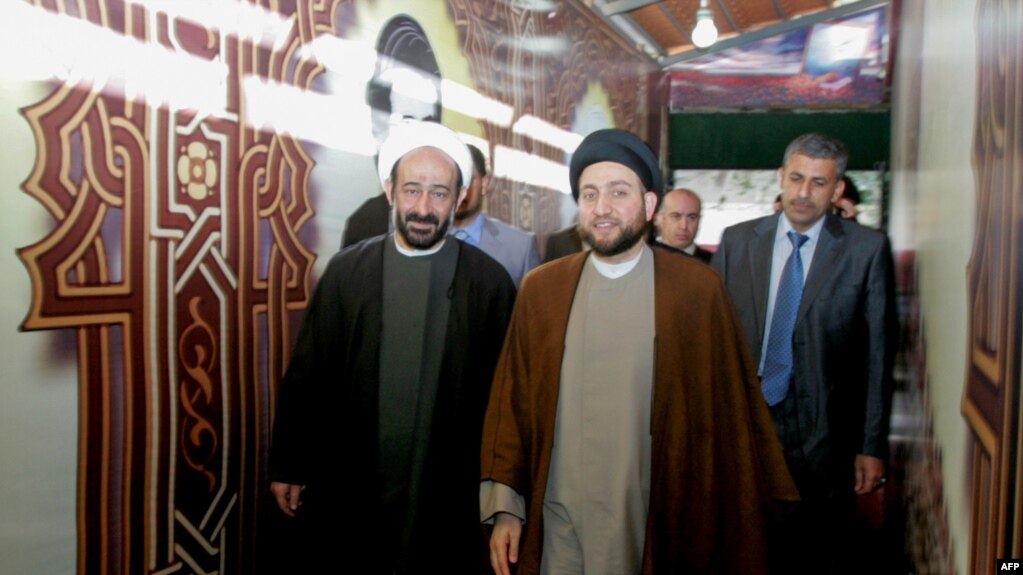 A picture taken in 2010 shows Lebanese Shiite cleric Muhammad Kawtharani (L), who has long spearheaded Hezbollah's Iraq policy, alongside Iraqi Shiite Muslim leader and head of Hikma party Ammar al-Hakim (C) during a visit to the gravesite of assassinated