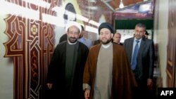 A picture taken in 2010 shows Lebanese Shiite cleric Muhammad Kawtharani (L), who has long spearheaded Hezbollah's Iraq policy, alongside Iraqi Shiite Muslim leader and head of Hikma party Ammar al-Hakim (C) during a visit to the gravesite of assassinated