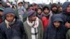 Migrants wait to be relocated during snowfall at the Lipa camp in northwestern Bosnia, near the border with Croatia on December 26.&nbsp;&nbsp;<br />
<br />
The Lipa migrant camp near Bihac was almost entirely destroyed by a fire that broke out on December 23, with many former residents left with nowhere to go.&nbsp;