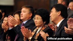 Then-parliament speaker Akmatbek Keldibekov (center left) stands next to former Kyrgyz President Roza Otunbaeva (center) at an early-October event.