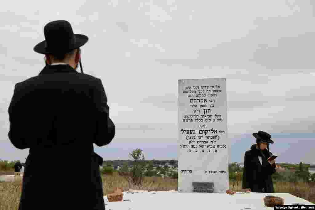 Pilgrims pray next to a tomb at an old Jewish cemetery on the eve of the Rosh Hashanah holiday, the Jewish New Year, in the town of Uman, Ukraine on September 19. (Reuters/Valentyn Ogirenko)