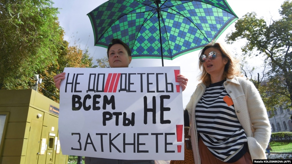 A woman holds a placard reading "You can't shut up everyone!" as journalists and supporters take part in a protest against censorship in Moscow in September.