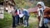 Bosnian Muslims speak with a survey taker during Bosnia's first census in the village Krusev Do, near Srebrenica, in October 2013.