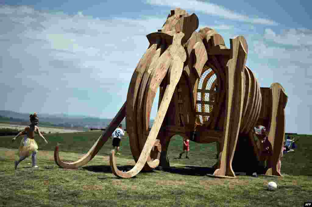 Children run by a mammoth sculpture at the newly opened Mammoth Park near the town of Kostolac, some 100 kilometers south east of Belgrade, Serbia, on June 30. (AFP/Andrej Isakovic)