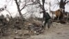 افغانستان:افغان پولیس په خوست کې د ځانمرګي بمي برید د پېښې د ځای پلټنه کوي.۲۰۱۱م کال ۱۸م فبروري