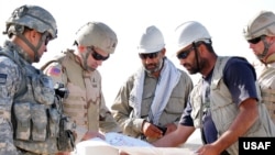 US and Afghan engineers review blueprints for an Afghan Army garrison in September 2008.