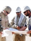 US and Afghan engineers review blueprints for an Afghan Army garrison in September 2008.