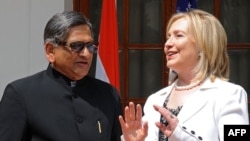 U.S. Secretary of State Hillary Clinton (right) talks with Indian Foreign Minister S.M. Krishna talks in New Delhi on July 19.
