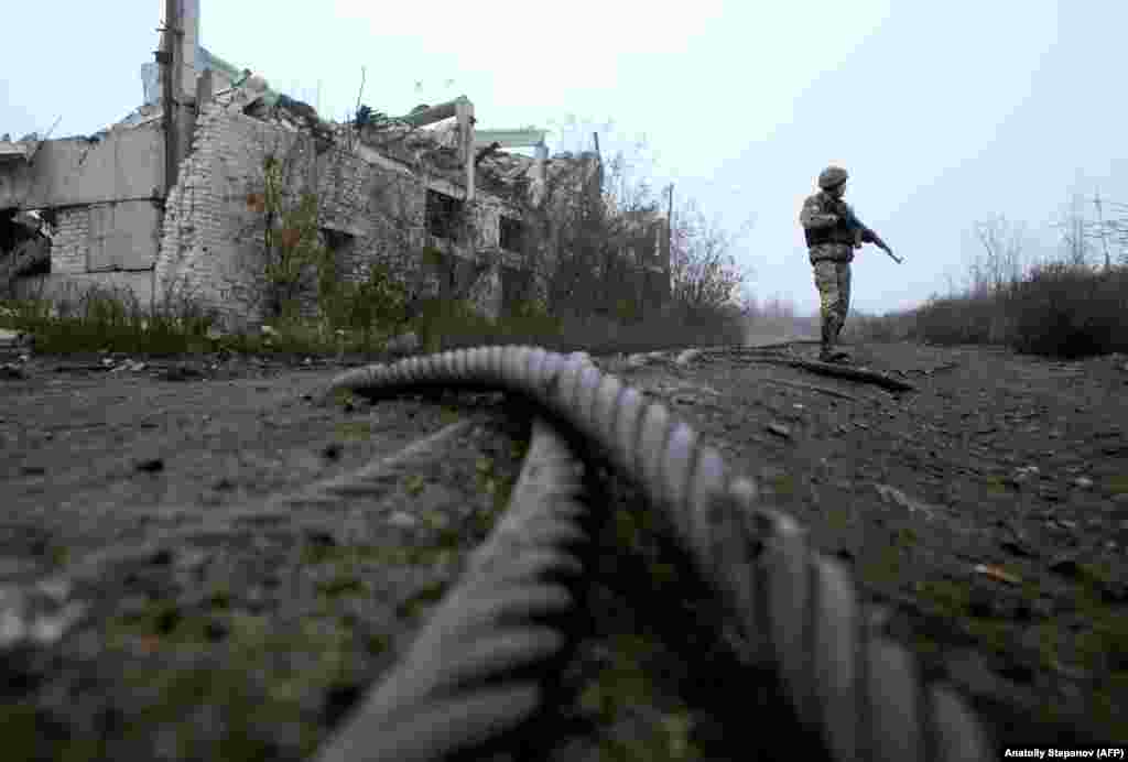 A Ukrainian soldier patrols by a destroyed coal mine of Butovka at the front line with Russia-backed separatists not far from the town of Avdiyivka in the Donetsk region. (AFP/Anatoliy Stepanov)
