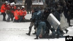 Ukrainian riot police arrest protesters in the center of Kyiv during clashes on January 22.