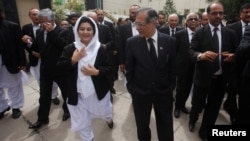 FILE: The Chief Justice of Pakistan Saqib Nisar speaks with Justice Mussarat Hilali while visiting the High Court in Peshawar, Pakistan.