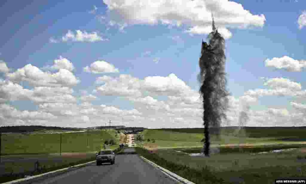 A mortar explodes close to a road leading to the city of Lysychansk in the Luhansk region on May 2.