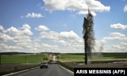 A Russian mortar shell explodes near the road leading to Lysychansk on May 23.