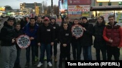 Stopkham activists line up for a photograph before traveling to a traffic-clogged highway for an evening of activism in Moscow.