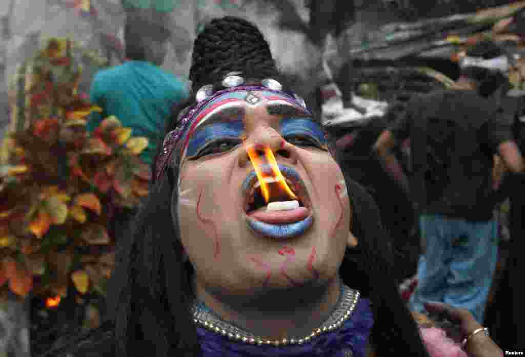 A man dressed as Hindu Lord Shiva performs with fire during a religious procession at the Mahashivratri festival in the northern Indian city of Allahabad on February 27. (Reuters/Jitendra Prakash)