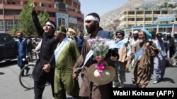 FILE: Afghan peace activists shout slogans in demand to an end to the war during a march from Helmand as they arrived in Kabul in June.