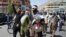 FILE: Afghan peace activists shout slogans in demand to an end to the war during a march from Helmand as they arrived in Kabul in June.