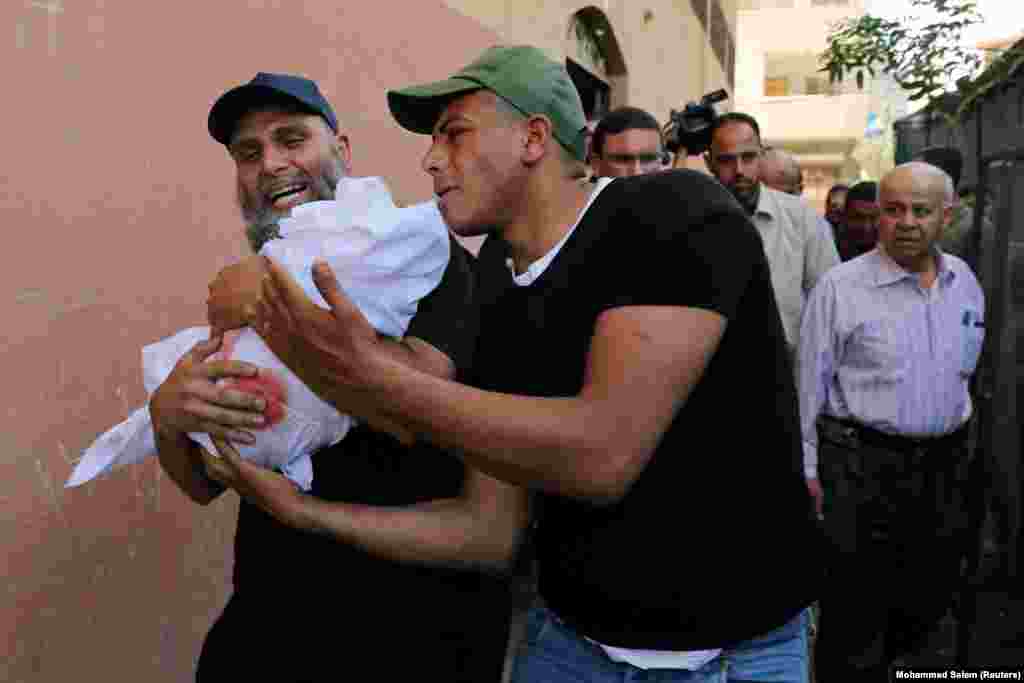 Relatives carry the body of 4-month old Palestinian girl Maria al-Ghazali during her funeral in Gaza City. A cease-fire deal ended the deadliest fighting between Israel and Palestinian militants in the West Bank and Gaza Strip since a 2014 war. A two-day outbreak of violence killed 25 people in Gaza, both militants and civilians, and four civilians in Israel. (Reuters/Mohammed Salem)